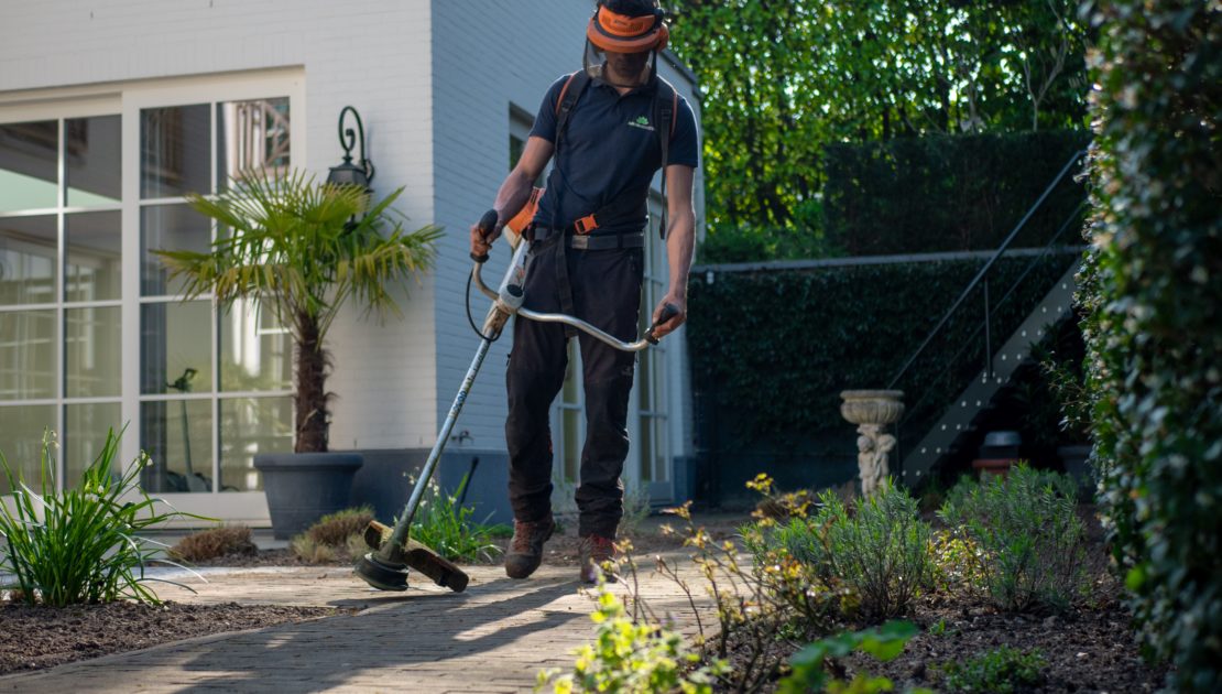Professional hardscape crew working on a residential driveway project
